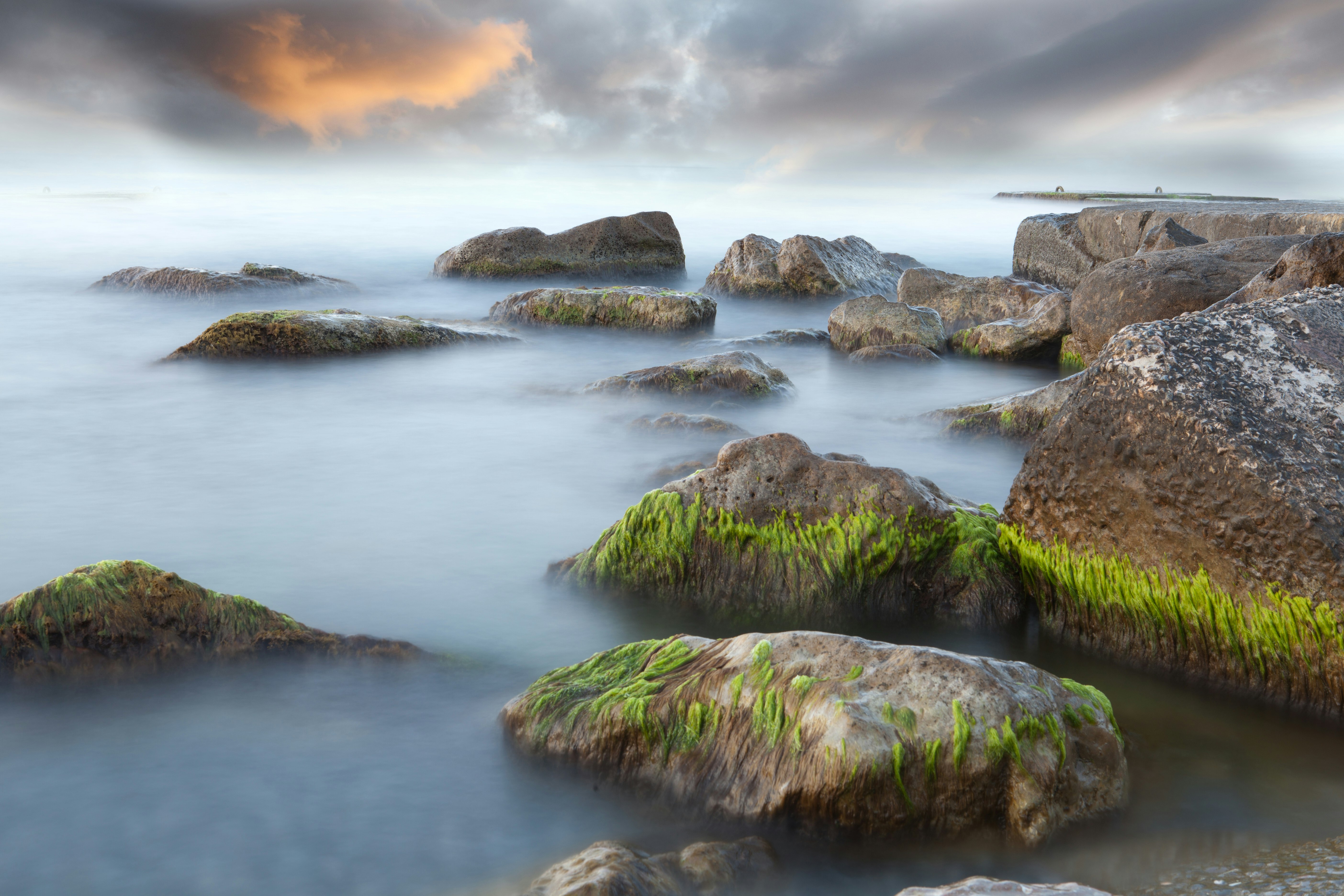 brown and gray rocks at water during daytime